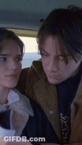 A Man And A Woman Looking At Each Other GIF