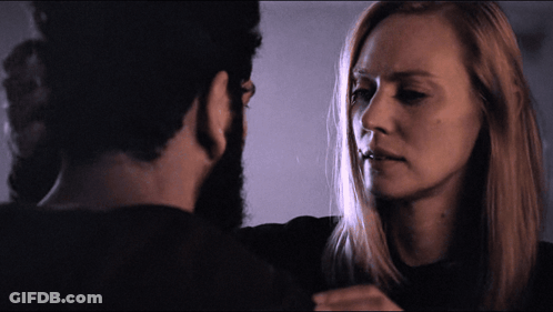 A Man And A Woman Looking At Each Other GIF
