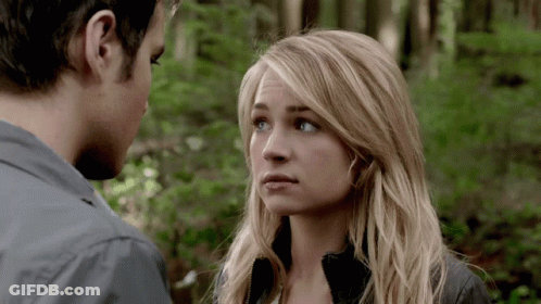 Man And Woman Looking At Each Other With Trees In Background GIF