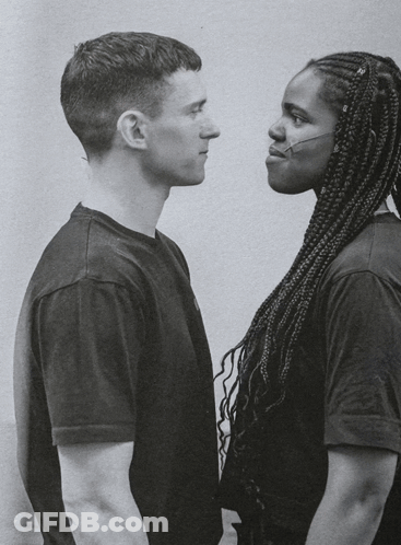 A Man And A Woman Looking At Each Other GIF