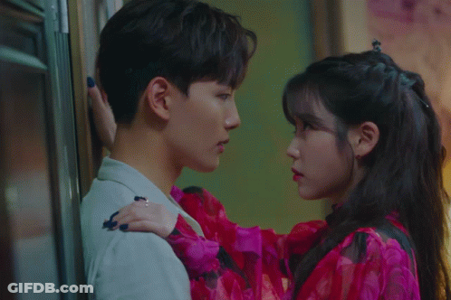 A Man And A Woman Looking Into Each Others Eyes GIF