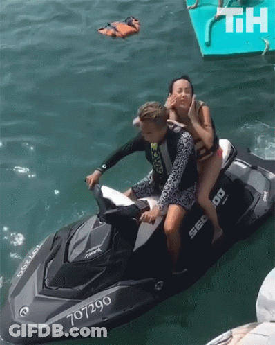 A Man And A Woman On A Jet Ski With The Number 707290 GIF