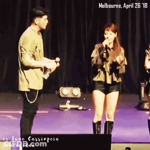 A Man And A Woman On A Stage With The Date April 26 18 GIF