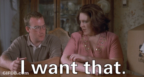 A Man And A Woman Sit At A Table With The Words I Want That GIF