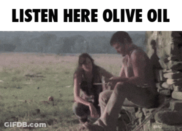 A Man And A Woman Sit In A Field With The Words Listen Here Olive Oil GIF