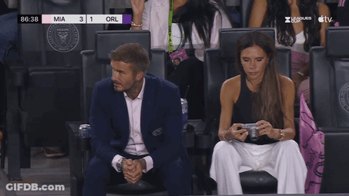 A Man And A Woman Sit In A Stadium Watching A Soccer Game With The Score Of Mia 3 1 Orl GIF