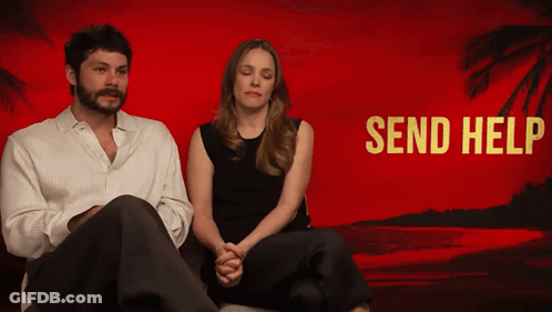 A Man And A Woman Sit In Front Of A Red Background That Says " Send Help " GIF