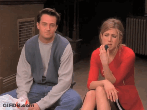 A Man And A Woman Sit Next To Each Other Eating GIF