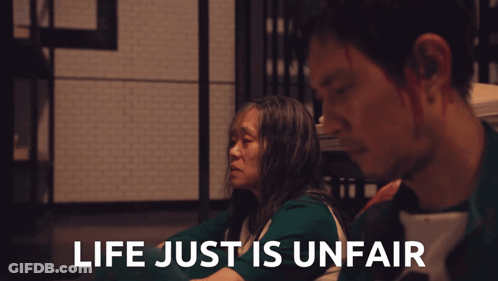A Man And A Woman Sit Next To Each Other With The Words Life Just Is Unfair GIF