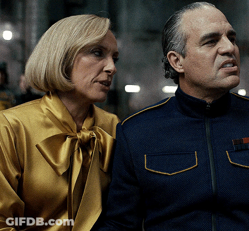 A Man And A Woman Sitting Next To Each Other GIF