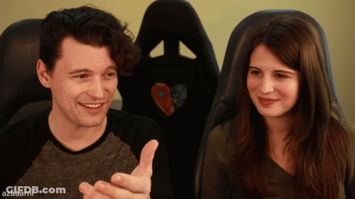 A Man And A Woman Sitting Next To Each Other With Azaarni Written On The Bottom Right GIF