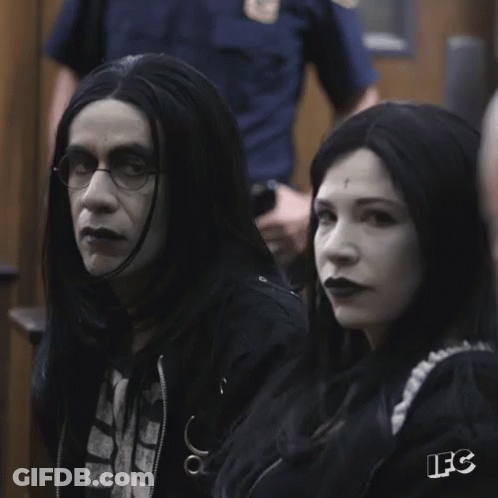 A Man And A Woman Sitting Next To Each Other With The Letters Ifc On The Bottom Right GIF