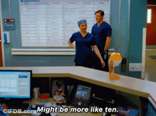 Man And Woman In Front Of Desk Say Might Be More Like Ten GIF