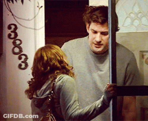 A Man And A Woman Standing In Front Of A Door With The Number 3333 On It GIF