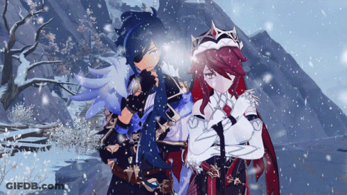 A Man And A Woman Standing In The Snow With Their Arms Crossed GIF