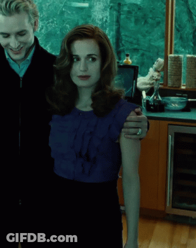 A Man And A Woman Standing Next To Each Other GIF