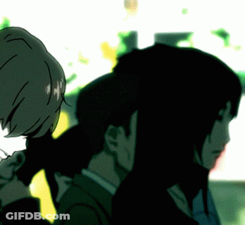 A Man And A Woman Standing Next To Each Other In A Dark Room GIF