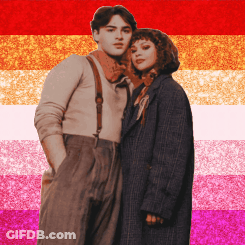 A Man And A Woman Standing Next To Each Other In Front Of A Pink And Orange Striped Background GIF