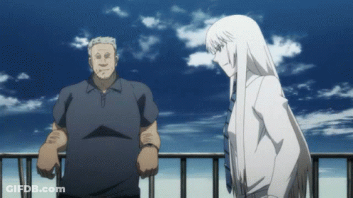 A Man And A Woman Standing Next To Each Other On A Balcony GIF