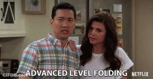 A Man And A Woman Standing Next To Each Other With Advanced Level Folding Netflix Written On The Bottom Right GIF