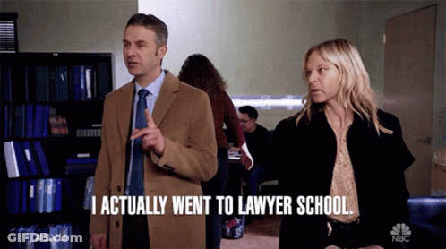 A Man And A Woman Standing Next To Each Other With The Man Saying I Actually Went To Lawyer School GIF