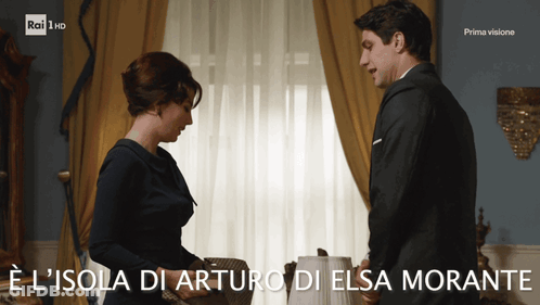A Man And A Woman Standing Next To Each Other With The Words E L Isola Di Arturo Di Elsa Morante GIF