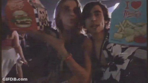 A Man And A Woman Standing Next To Each Other With The Words " Got It " On The Bottom Right GIF