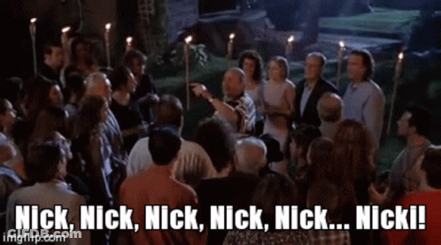 A Man And A Woman Standing Next To Each Other With The Words Nick Nick Nick Nick Nick Nick Written On The Screen GIF