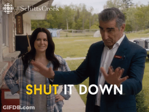 A Man And A Woman Standing Next To Each Other With The Words Shut It Down Written In Yellow GIF