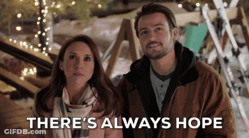 A Man And A Woman Standing Next To Each Other With The Words " There 'S Always Hope " Behind Them GIF
