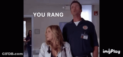 A Man And A Woman Standing Next To Each Other With The Words " You Rang " On The Bottom GIF