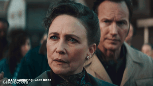 A Man And A Woman Standing Next To Each Other With #Theconjuring Last Rites Written On The Bottom GIF