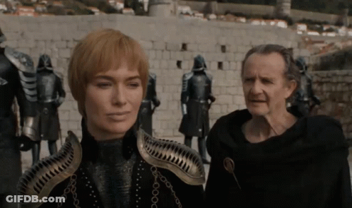 A Man And A Woman Standing Next To Each Other GIF