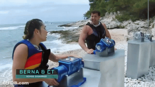 A Man And A Woman Standing On A Beach With The Name Berna & Ct On The Bottom GIF