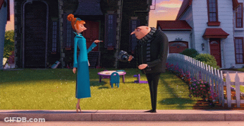 A Man And A Woman Standing On The Sidewalk In Front Of A House GIF