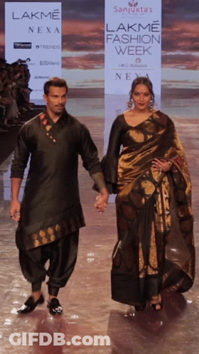 A Man And A Woman Walk Down A Ramp For Lakme Fashion Week GIF