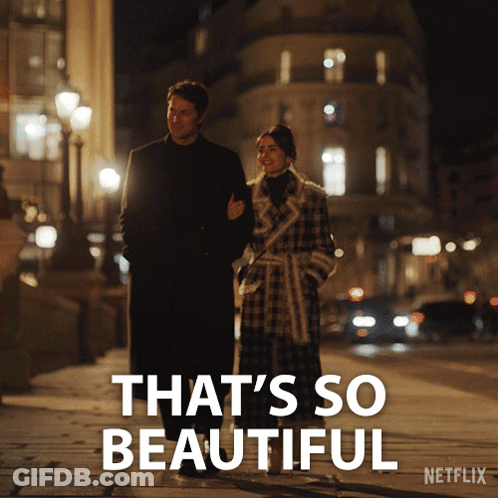 A Man And A Woman Walking Down A Street With The Words That 'S So Beautiful On The Bottom GIF