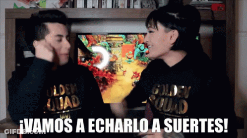 A Man And A Woman Wearing Golden Squad Sweatshirts Are Playing A Video Game GIF