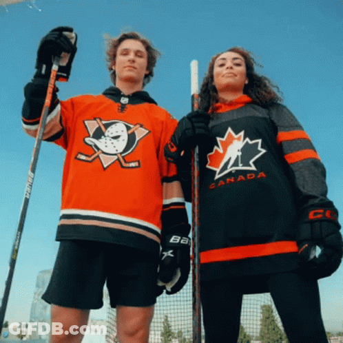 A Man And A Woman Wearing Jerseys That Say Canada GIF