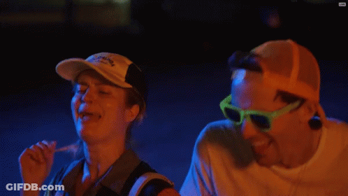 Man And Woman Laughing In Sunglasses And Red Bull Hat GIF