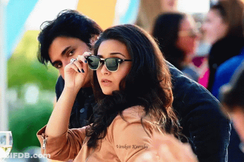 A Man And A Woman Wearing Sunglasses Are Sitting Next To Each Other In A Photo Taken By Vikram Kaurkey GIF