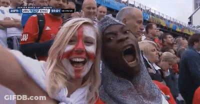 A Man And A Woman With Their Faces Painted In The Colors Of The England Flag GIF