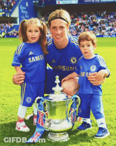 A Man And Two Children Pose For A Picture With A Trophy GIF