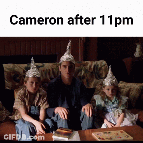 A Man And Two Children Wearing Aluminum Foil Hats Sit On A Couch With The Caption Cameron After 11 Pm GIF