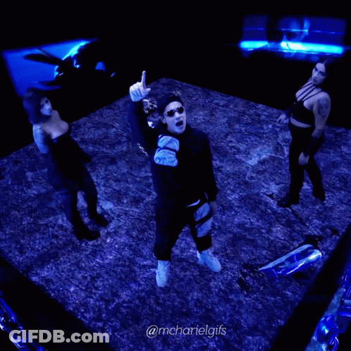 A Man And Two Women Are Dancing In A Dark Room With The Hashtag @Mchartelgifs On The Bottom GIF
