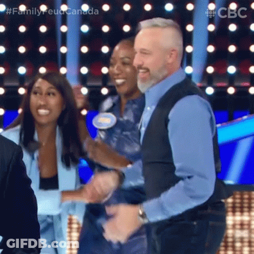 A Man And Two Women Are Dancing On A Stage . GIF