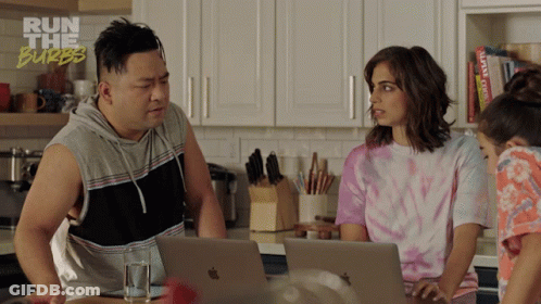 A Man And Two Women Are Looking At Laptops In A Kitchen With The Words Run The Burbs On The Bottom Right GIF