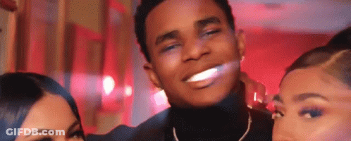 A Man And Two Women Are Posing For A Picture And Smiling For The Camera . GIF