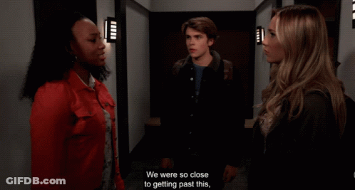 A Man And Two Women Are Standing In A Hallway And One Of Them Says " I Understand " GIF