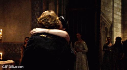 A Man And Woman Are Dancing In A Dark Room GIF